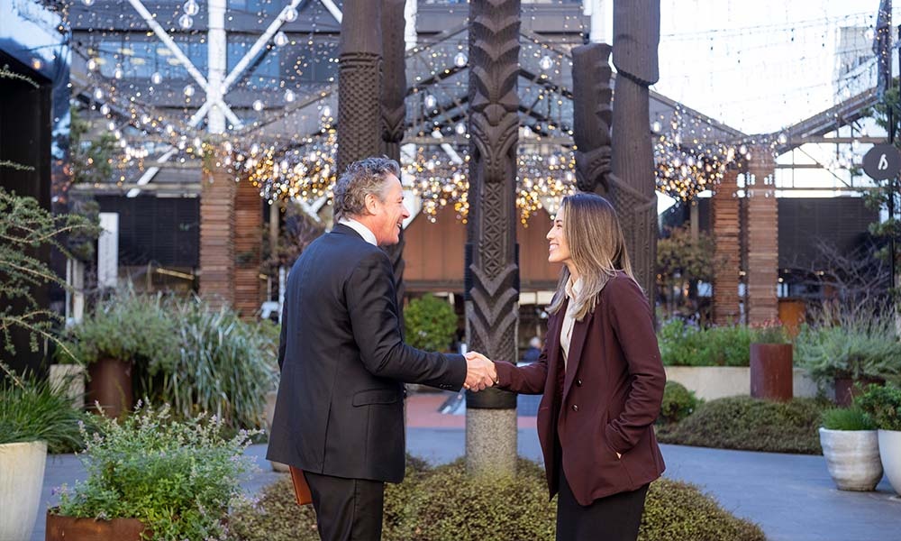 Man and woman shaking hands in Auckland city