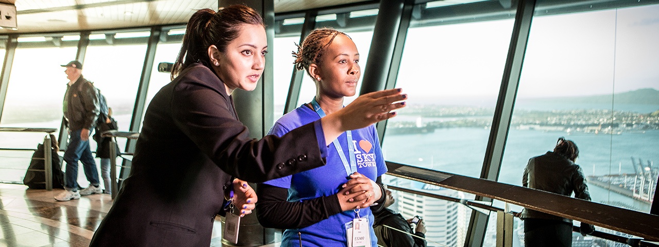 A young person working as a visitor guide at the Sky Tower