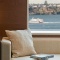 A sofa inside a hotel room with a view out to the Waitemata Harbour