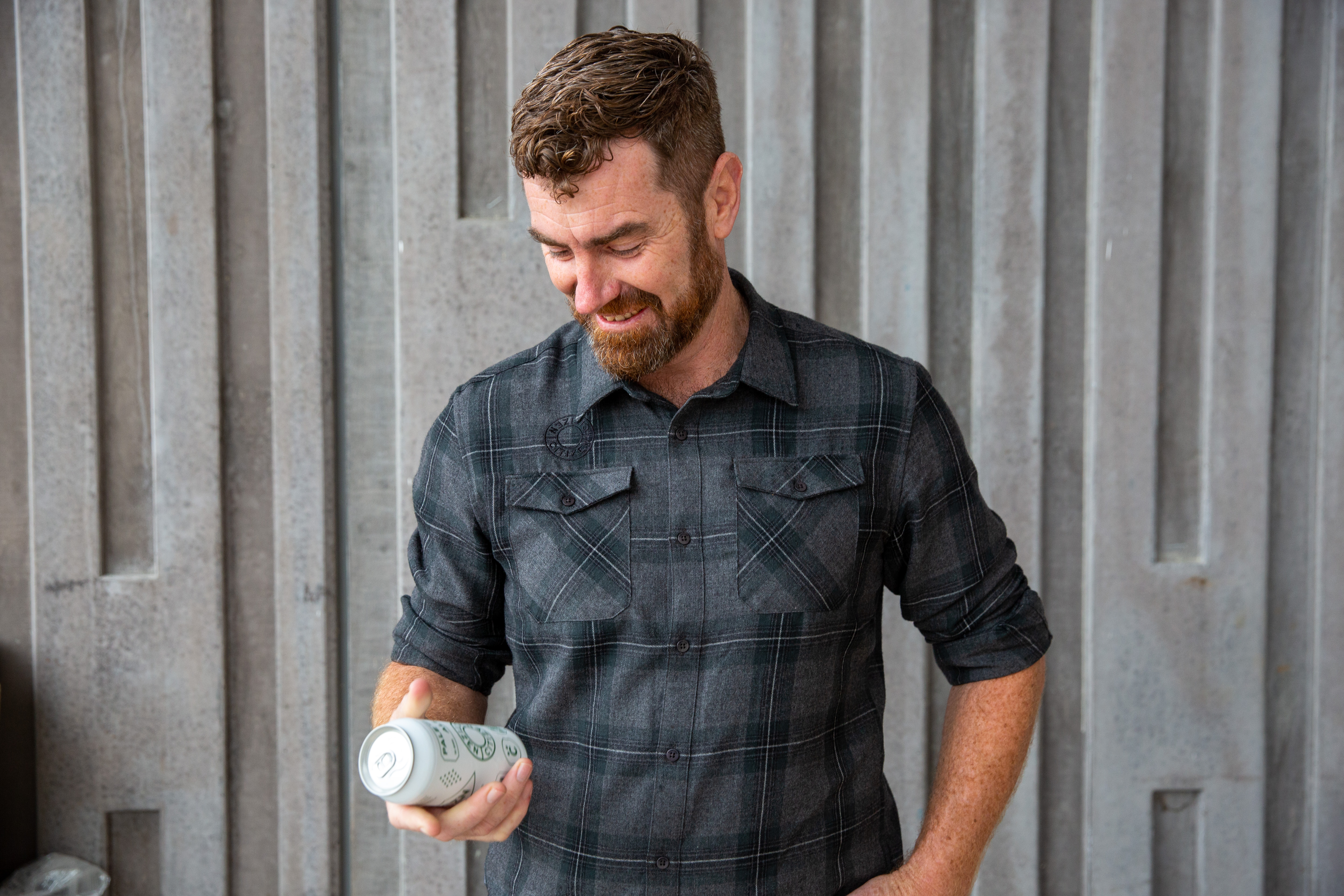 Donald Shepard holding beer can in hand looking down