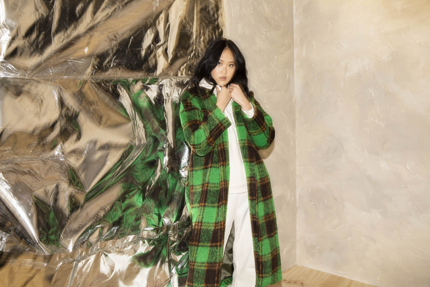 Fashion model posing in green tartan jacket