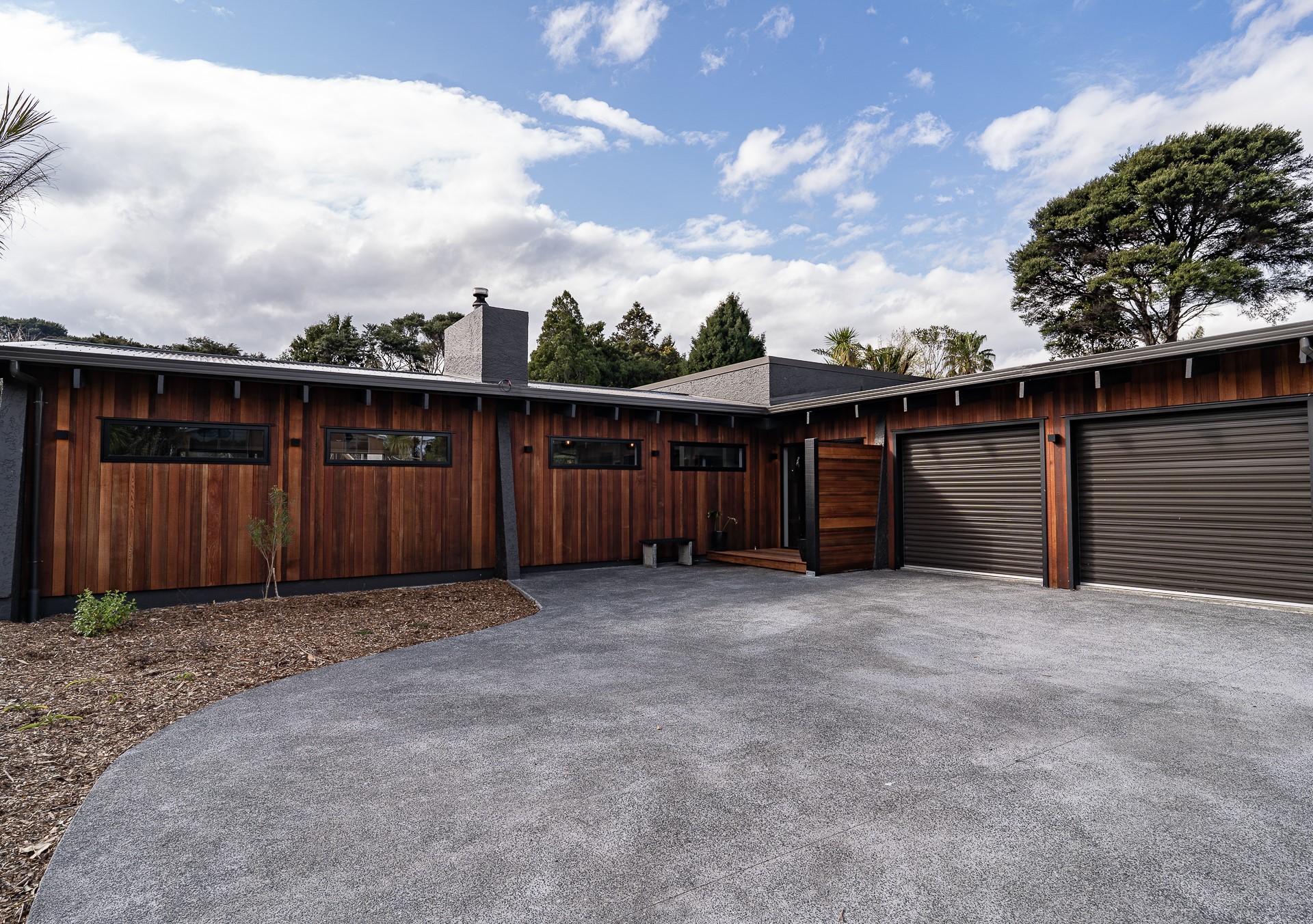 Wide shot of driveway and front of house