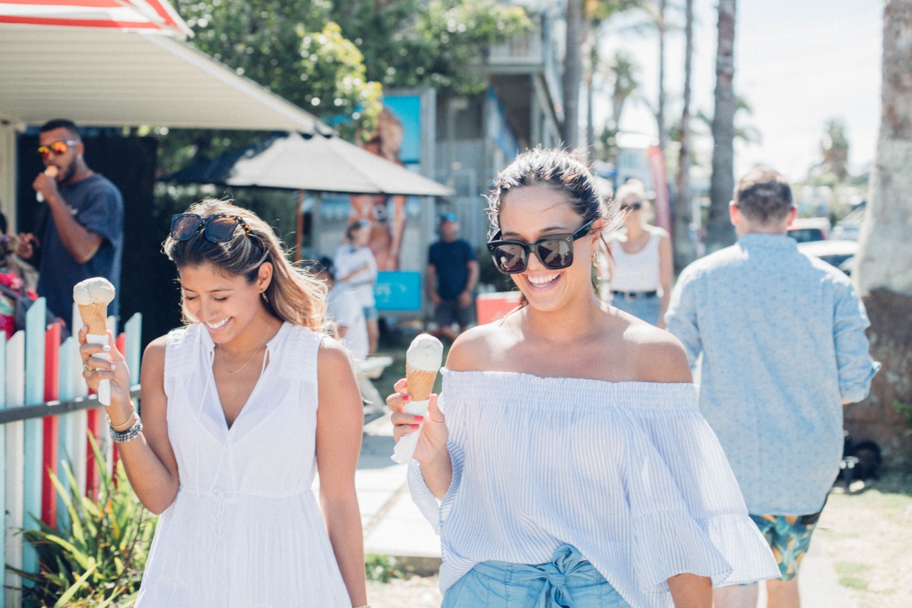 Two women eating ice creams on a sunny day