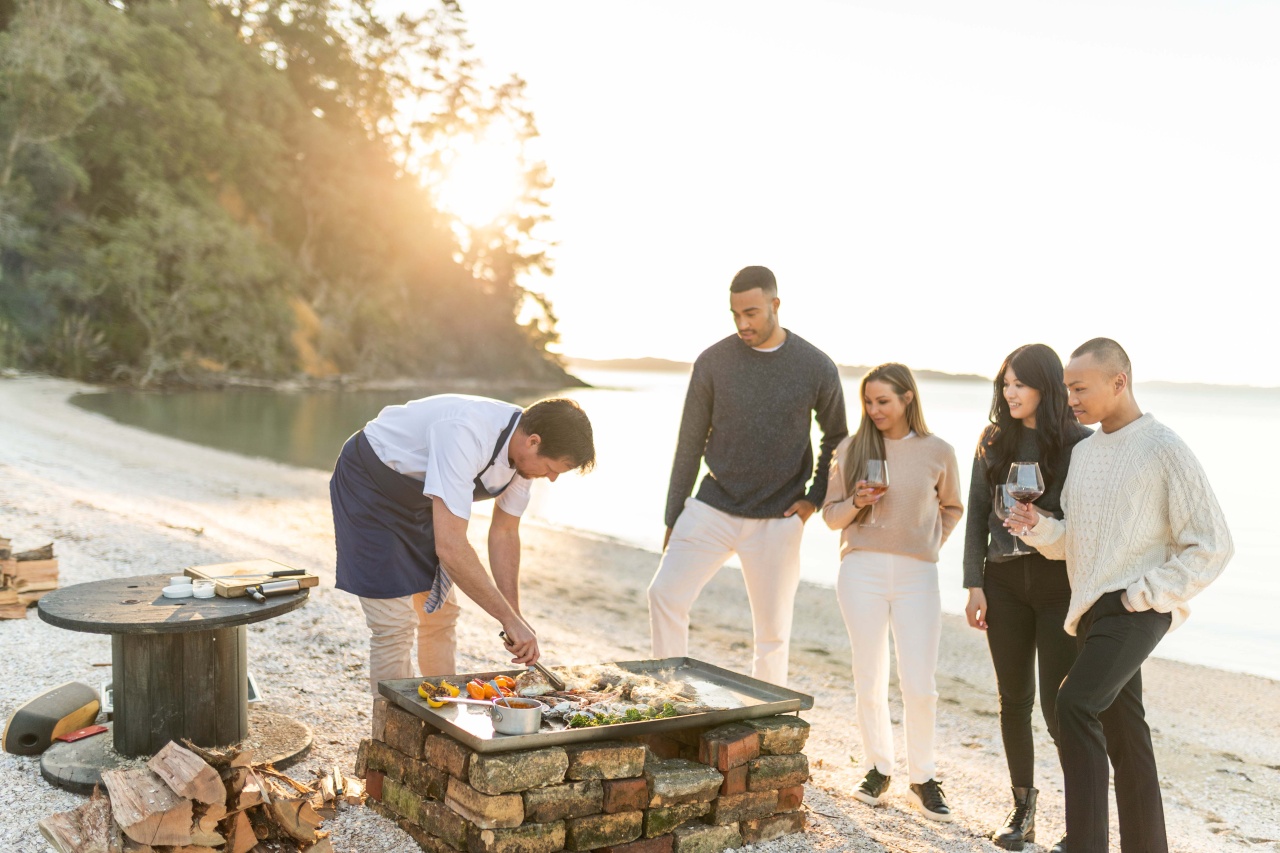 Delegates watching a chef cook on the beach