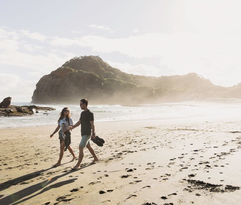 Tech Auckland - Place - Couple enjoying Auckland beach walk