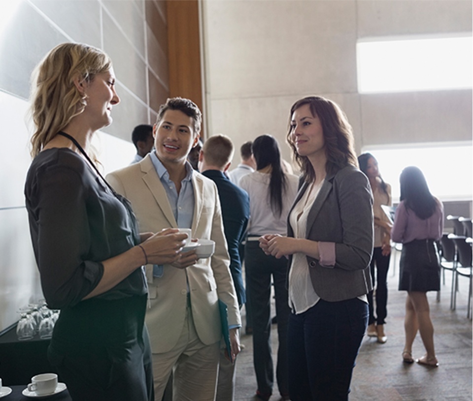 Group of three networking at an event