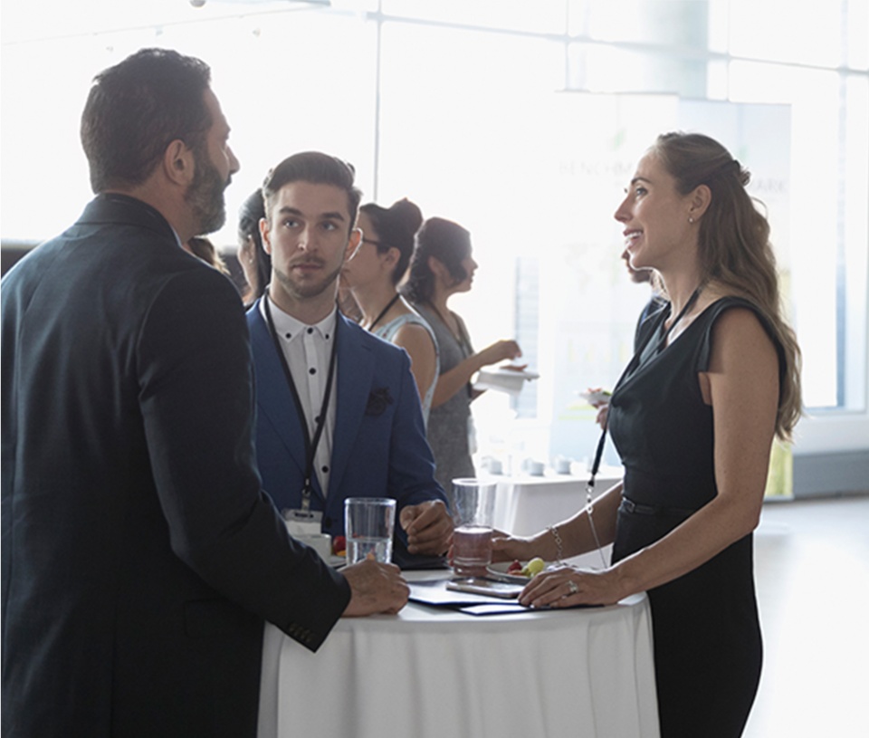 Group of three networking at an event