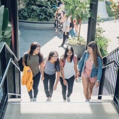 Four students walking up an outdoor staircase
