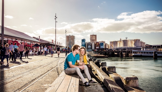 A couple relaxing at Auckland's busy North Wharf